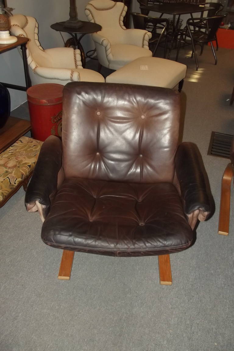 A four piece salon set with bent wood frames and its original leather cushions.  This set is modular consisting of four identical chair units.  One chair unit is shown with arms, one without.  The settee consists of two chair units shown without