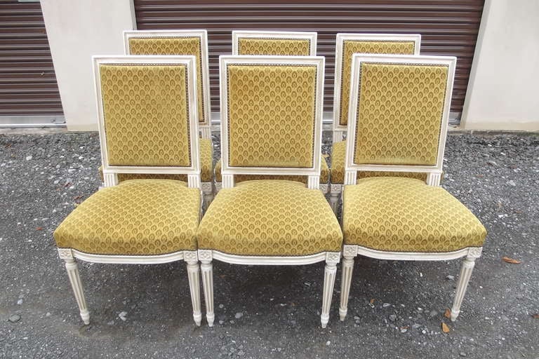 A set of six large-scale Louis XVI-style dining chairs. These chairs have their original white painted surface, in very good condition. The upholstery is original and in reasonably good condition.
