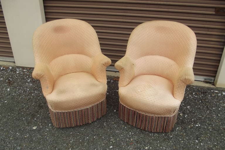 A pair of large scale period Napoleon III armchairs in as found condition.  This size is unusual for the round top style chairs.  The chairs are in very good as found condition structurally, but the upholstery is quite worn and needs replacement. 