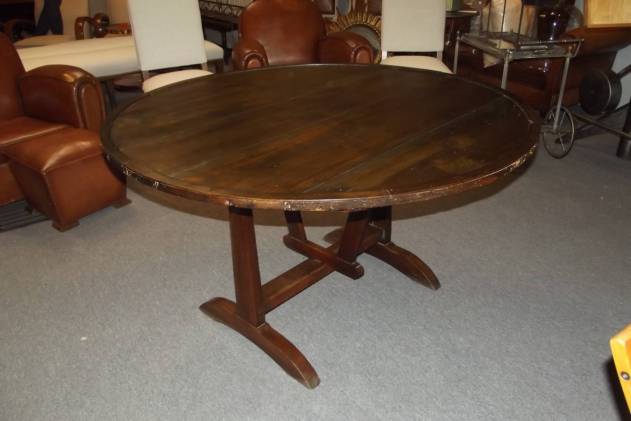 A late 19th century French wine tasting table in an old mellow surface.  The table is in very good structural condition and is quite sturdy.  The top is soft wood and the base is oak.