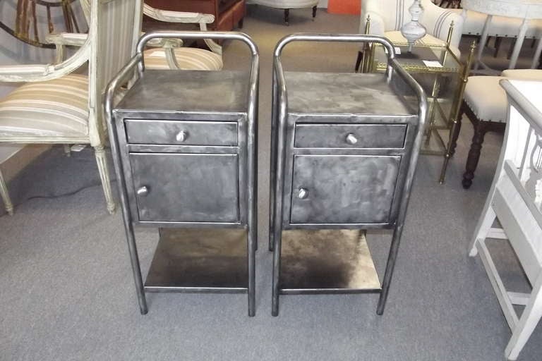 Pair of French polished steel nightstands with a drawer, cabinet, and bottom shelf. Cleaned, polished, and coated with three layers of satin lacquer.