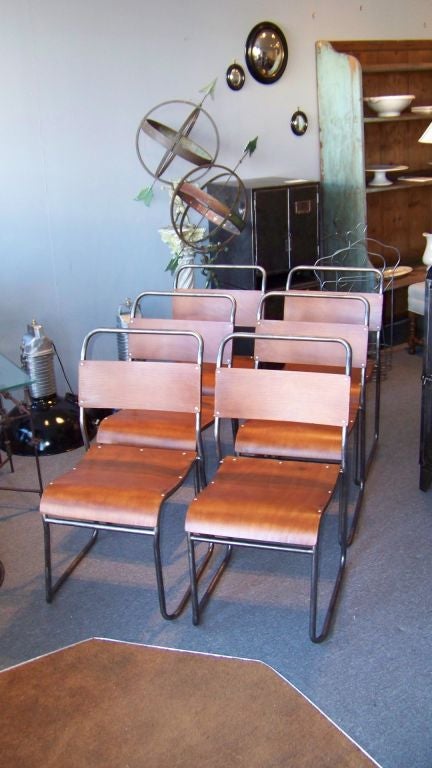 A set of twelve PEL chairs with polished steel frames and bent plywood seats and backs.  Chairs are available individually.  Pricing is per chair.