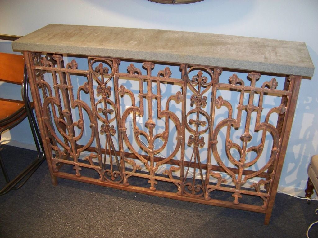 A wrought iron console constructed from a 19th century balcony front and fitted with bluestone top.