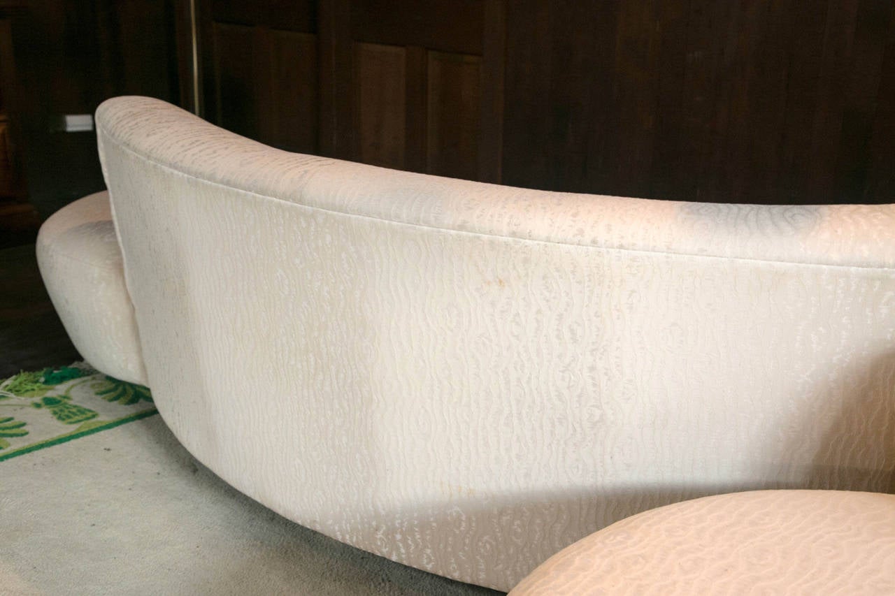 One 1980 Vladimir Kagan serpentine cloud sofa. One left arm. Original cream colored fabric. Best to recover. 