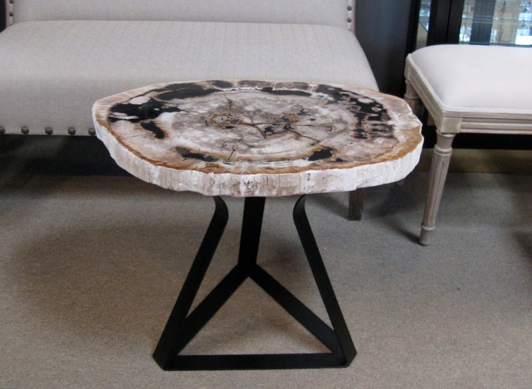 Unusual petrified wood side / end table with custom designed triangular iron base.
The base was made to enhance the beauty of the top. Polished removable table top is 1.50 inches thick, with exquisite variegated color.

PLEASE NOTE: Petrified
