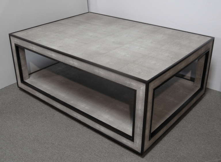 A classic rectangular double tiered coffee table wrapped in faux shagreen, with a narrow wood edge.
Although this is faux shagreen, it very closely duplicates the actual skin. See images 3 and 4 for close ups.