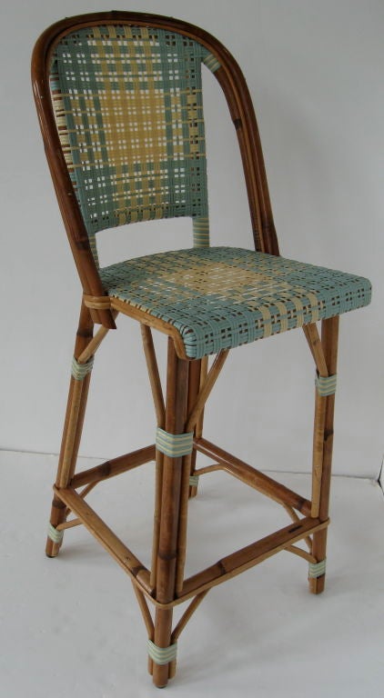 Set of three bamboo and rattan bar stools, hand made by the T.K. French Company.<br />
This company is known for their quality of workmanship and attention to detail.  These stools are the same type found in Paris cafes.  They are constructed of