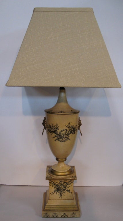 This elegant pair of painted tole lamps, made in the 1950's in Italy, have been inspired by the original 18th century tole lamp.  There are black stenciled decorations and gold accents, with 