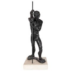 Bronze Man With a Staff by Dori Gallione on a White Marble Base