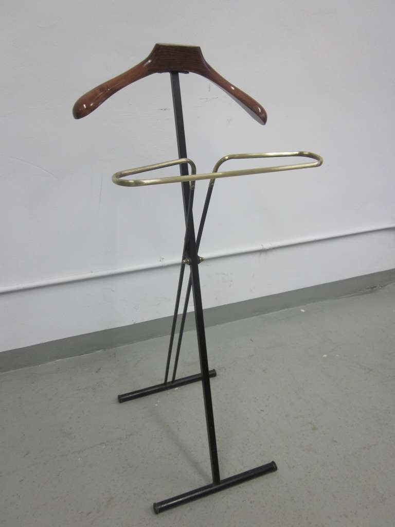 Pair of French Mid-Century personal valets / coat stands in a sober, modern style including a solid brass pants hanger. Fully collapse-able.

Priced individually.