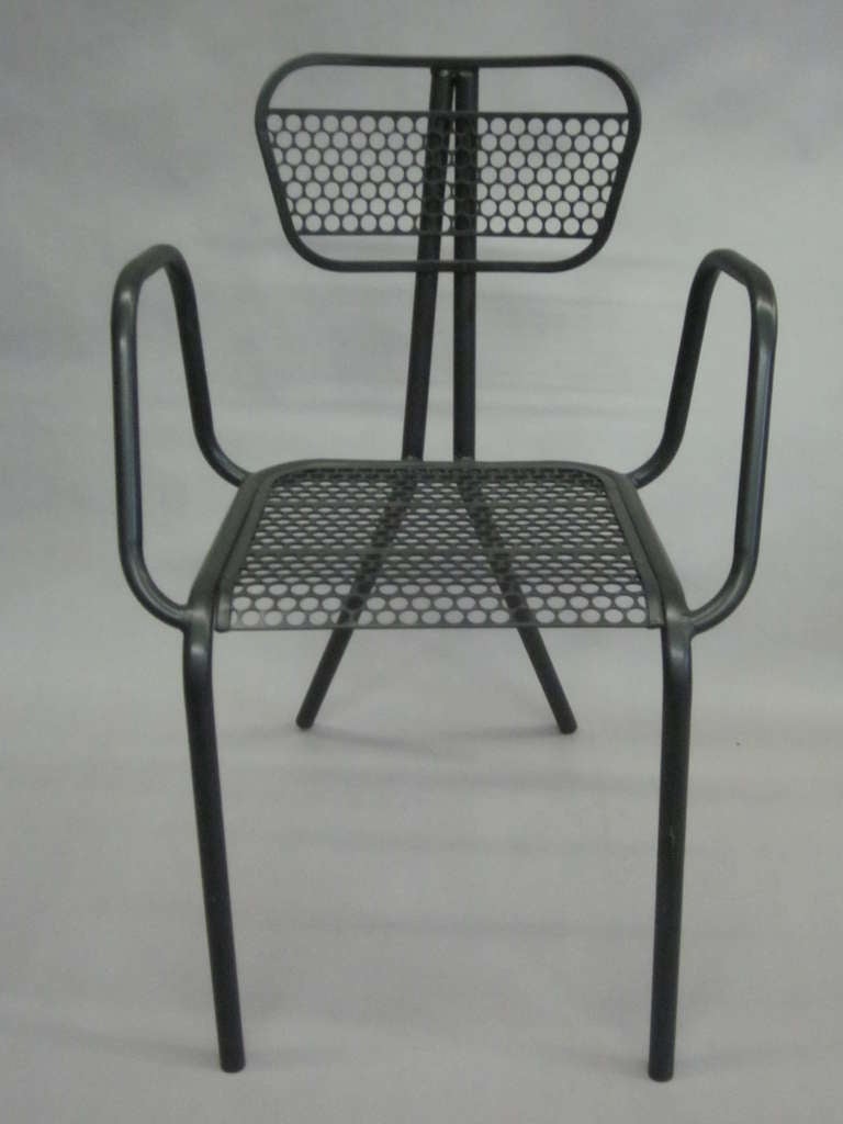 A Rare, had to find set of Eight French Mid-Century Modern or Industrial style dining room chairs in black enameled steel. The chairs feature a modern, transparent aesthetic that allows one to see through the elegant steel frames. Each armchair is