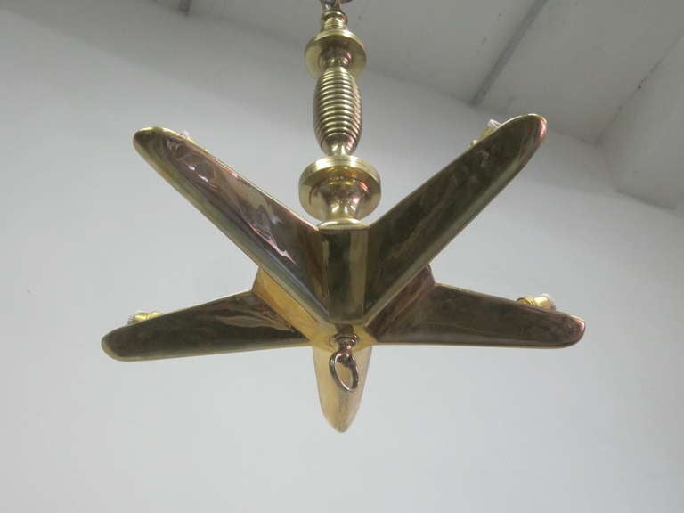 Elegant, Timeless French Midcentury chandelier / pendant / lantern in the Modern Neoclassical spirit in the form of a star or sunburst with lighting sockets secluded in each arm. The fixture is 20