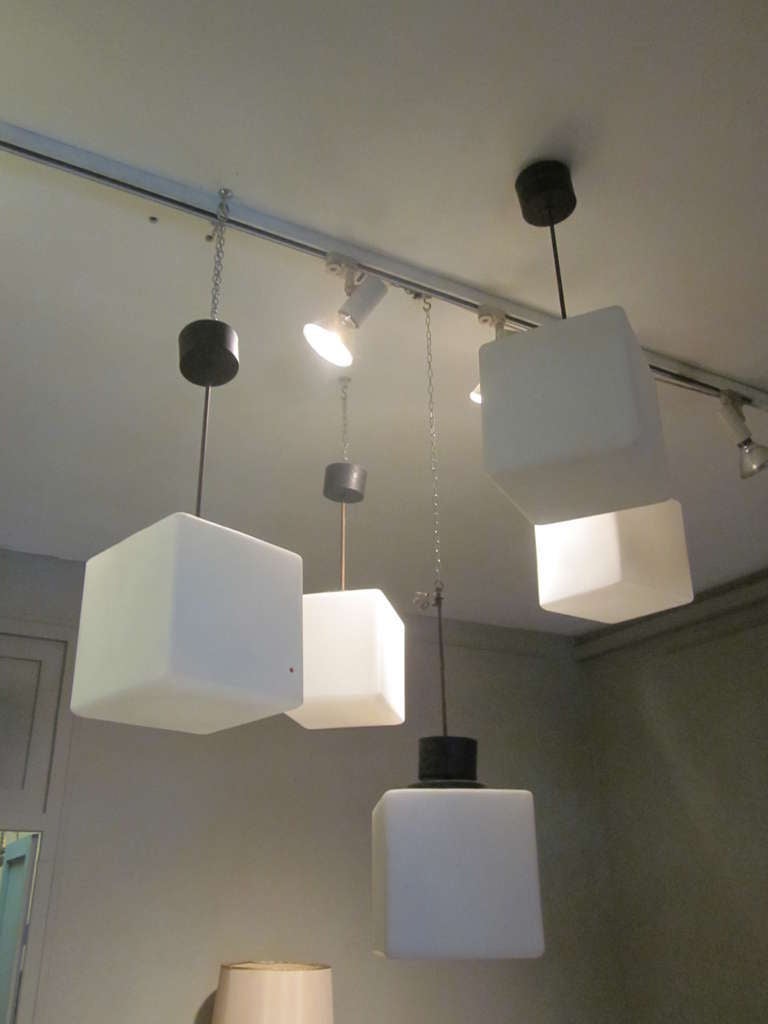 2 Pairs of  Italian Mid-Century Modern rectangular satin milk glass pendants / lanterns / flush mount fixtures with off-setting black round holders and canopies. The contrast and integration of black / white and rectangular / round forms creates