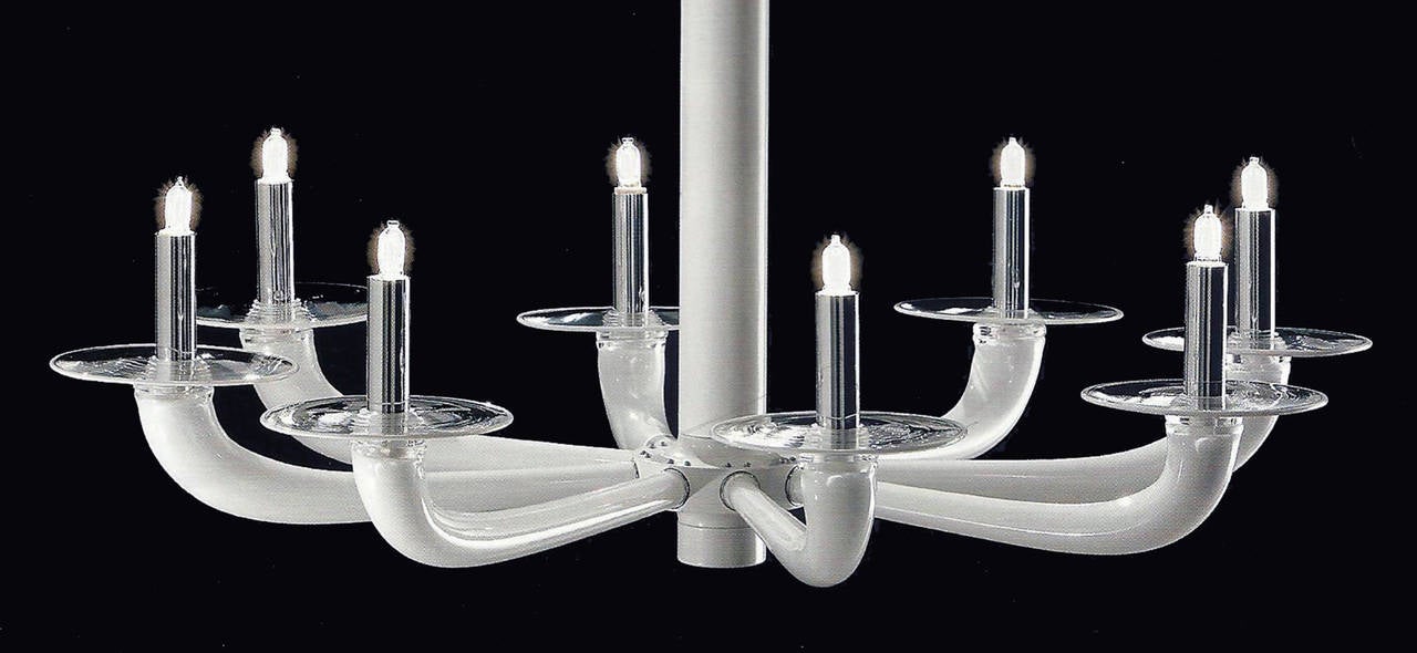 A pair of pure, elegant Italian modern chandeliers or pendants with eight handblown white venetian glass arms. Chrome details. 

The chandelier body alone is 23.63