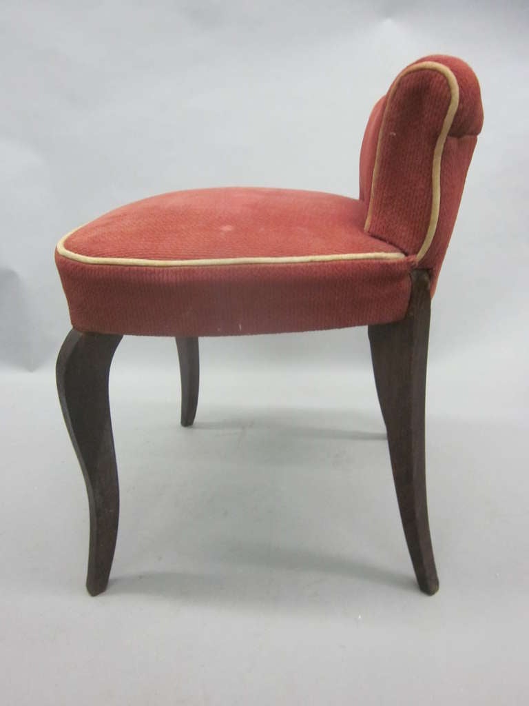 Elegant French Mid-Century Modern Neoclassical / Art Deco vanity chair or stool attributed to André Arbus circa 1930. The piece has a dramatic form including rear saber legs and cambered front legs. The upholstery is original and needs changing.