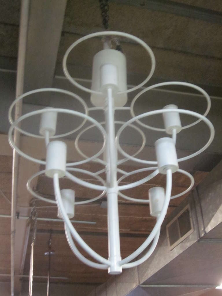 Italian Modernist chandelier attributed to Gino Sarfatti in enameled iron with eight arms each surrounded by a circular ring. Eight lights.