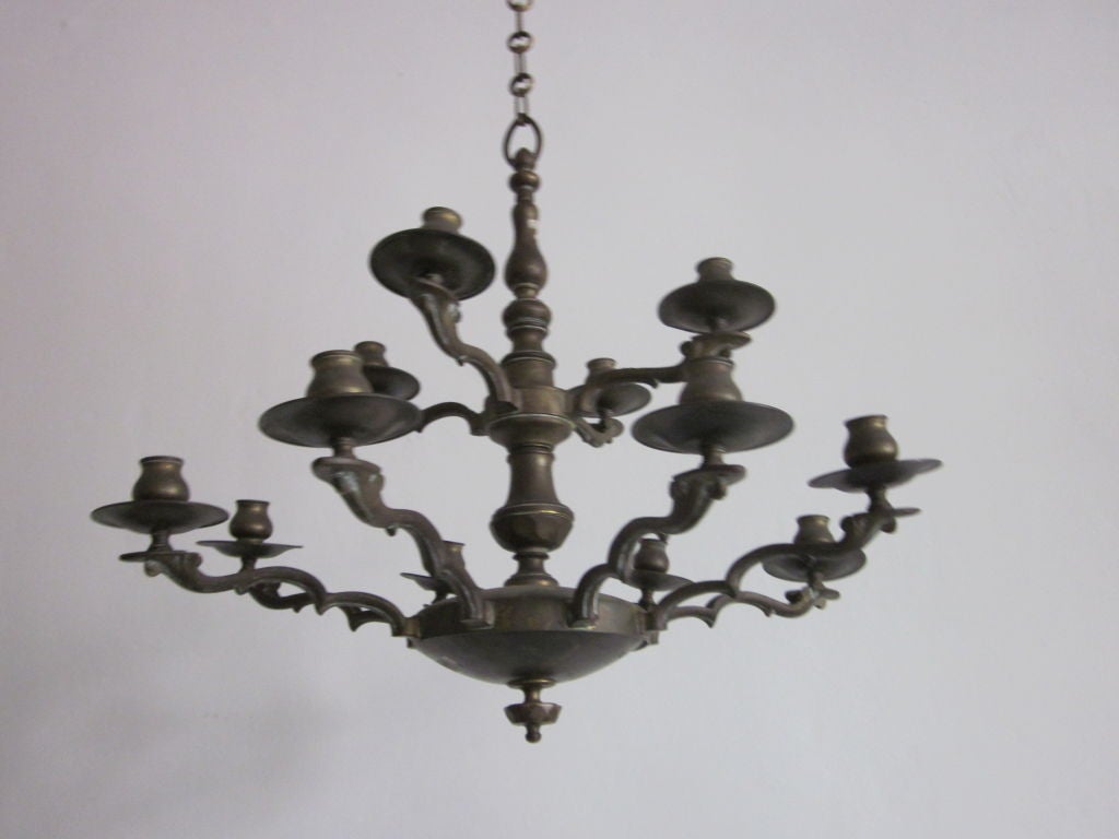 Timeless Italian solid brass / bronze double level chandelier with 12 arms in the neoclassical tradition.

Height of pendant is 24