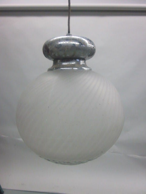 An elegant ball suspension fixture in souffled glass in swirl pattern. The top 2/3 in opaque glass and the bottom in a thick clear glass. Fixture is 15