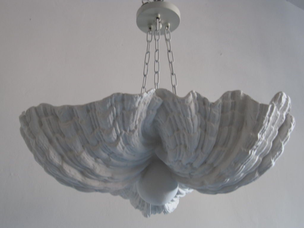 Rare French mid-century dramatic plaster pendants / chandeliers in the form of three intersecting sea shells by Jean Charles Moreux (1889-1956). Moreux was the first interior designer to bring the outdoors to the indoors and to pioneer the use of