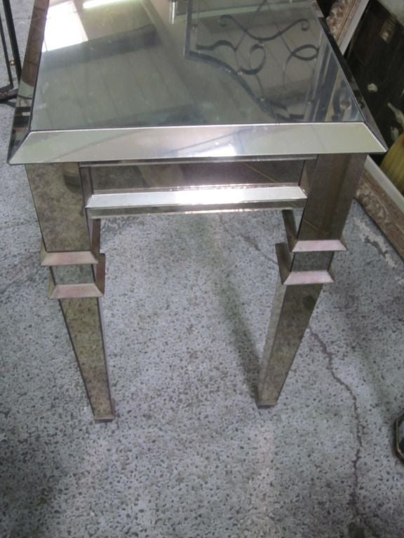 1 extraordinary French Art Deco / Mid-Century Modern style mirrored console or sofa table or vanity in the manner of Serge Roche with highest quality of design and craftsmanship. The piece is entirely mirrored in the Venetian style for dramatic
