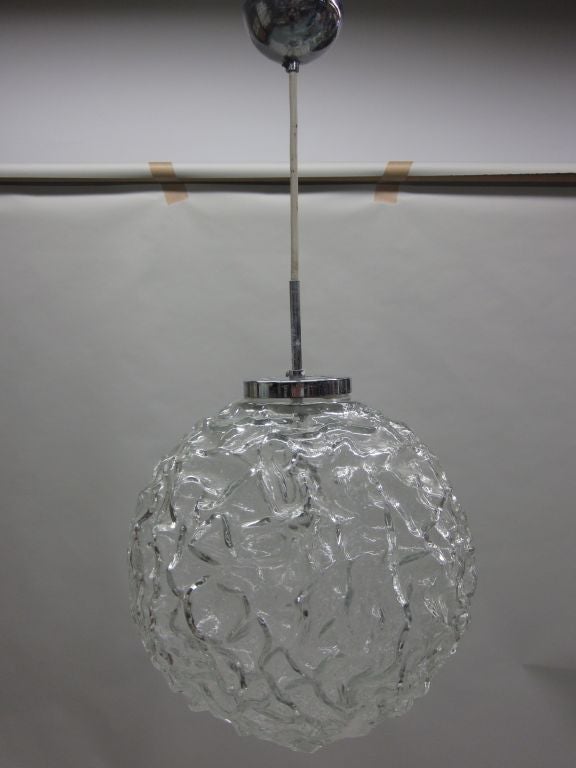 Clear Italian Mid-Century Modern mold blown glass ball pendant / lantern or flush mount fixture. The glass is shaped in a dimple pattern.

Fixture can mount to any desired height including flush mount via changing stem. Glass ball alone is 14 x 14
