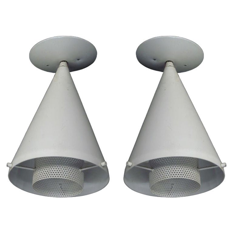 Pair of French Mid-Century Modern flush mount fixtures in the manner of Mathieu Mategot and in a conical form with an interior reflector in perforated metal. Available Individually.
