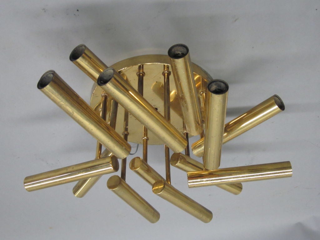 An elegant Italian Mid-Century Design 13-arm flush mount fixture in brass by Stilnovo. 

Gio Ponti designed similar modern fixtures.