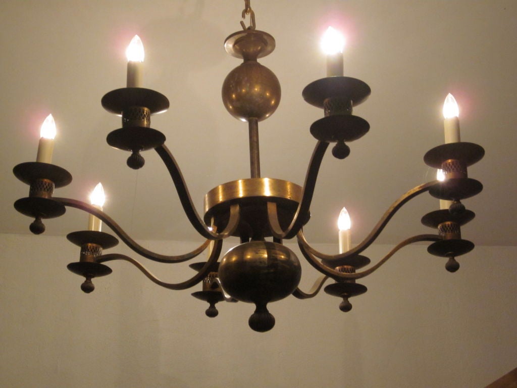 An Elegant French Mid-century brass chandelier or pendant with classic sober lines. Eight arms with wight Edison sockets. Rewired for US standards.

Height without chain and canopy is approximately 30