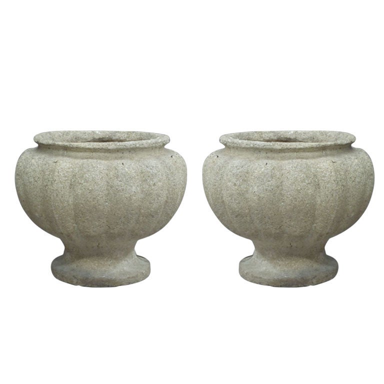 Elegant and Rare Pair of French Midcentury Modern Craftsman stone lamps in the style of Andre Arbus. The lamps are for table or floor and are created in a modern neoclassical voluted form gently tapering to form a round pedestal base. The pieces