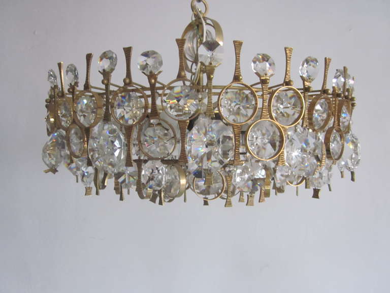 Pair of Italian Mid-Century Modern handmade crystal and gilt bronze chandeliers or pendants inspired by Angelo Brotto showing the influence of pre-neoclassical Etruscan primitivism and modern design. Each individual piece is made like a piece of