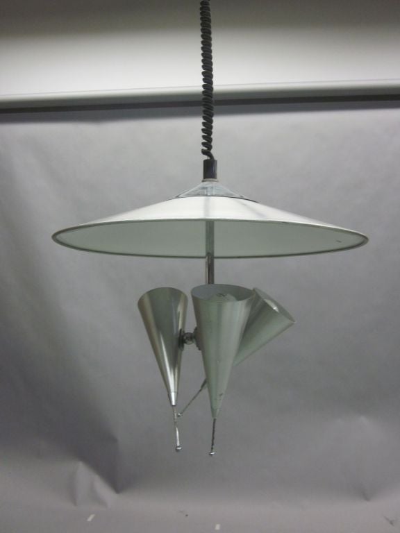 An Italian Mid-Century Modern Tri-reflector chandelier / pendant / fixture with a unique sculptural presence. Each reflector is adjustable to any angle and together the 3 reflectors can cast light in any three directions.

Height is variable as it