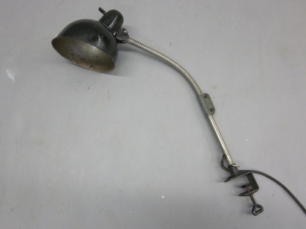 An early Christian Dell clamp lamp / task lamp (early version of model #6740 with an angled shade) for Kaiser Idell. Ideal clamped to a desk or bookshelf.

Stamped: Kaiser Idell on Shade

Christian Dell was the director of the Bauhaus metal workshop.