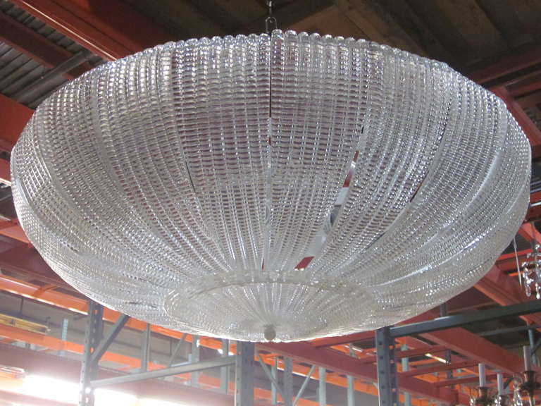 A large, elegant Italian Venetian glass chandelier or pendant in the style of Carlo Scarpa for Venini in a stunning domed form and in a sober, thick, clear mold blown glass pattern reminiscent of the modern neoclassical period of the 1930s. The