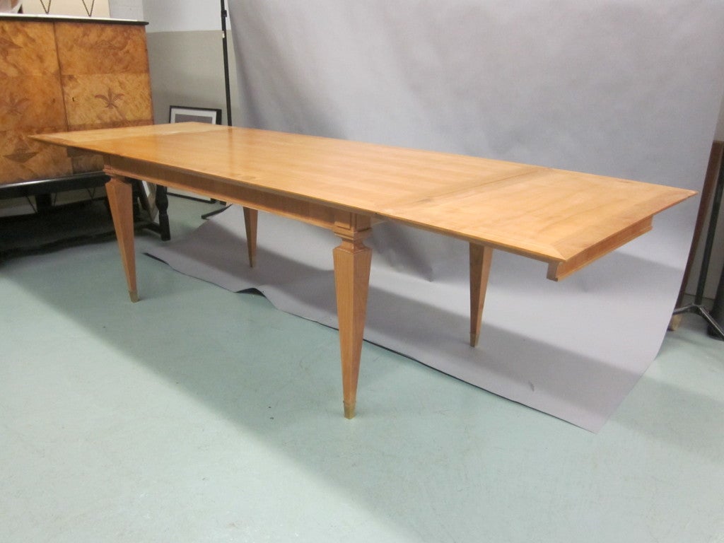 Elegant French dining room table in the modern neoclassical taste in cherry by Andre Arbus. 

Table without leaves is 72