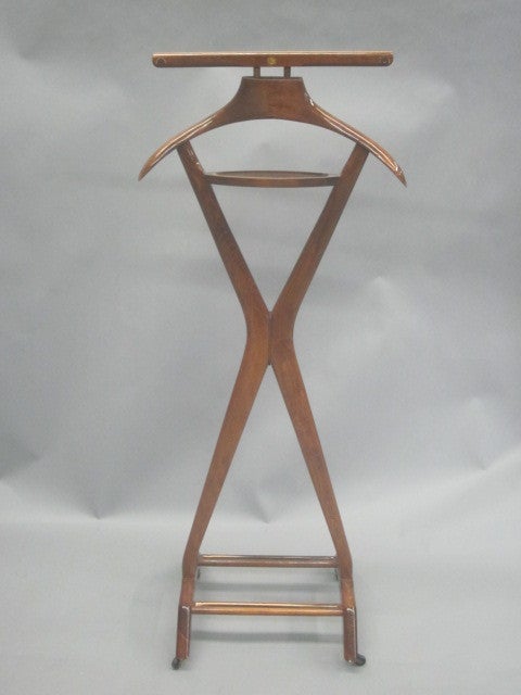 An Elegant Italian Mid-Century Modern Personal Valet or Coat Stand by Ico Parisi circa 1950 with storage for coat, shirt, tie, personal articles and shoes. The piece is exquisitely hand carved and hand crafted and fully multi-functional.