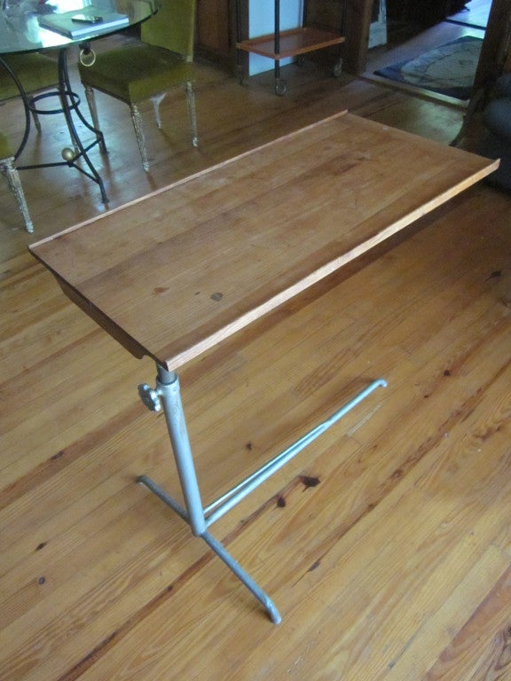 Swiss Mid-Century modernist adjustable use table useful as console, writing table or drafting table. The top rotates 360 degrees and both the height and angle of the top adjust according to need.