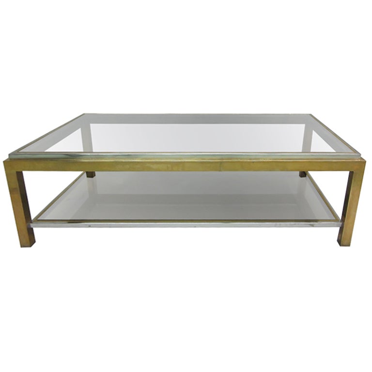 Elegant French Mid-Century Modern double tier coffee table in solid brass and polished nickel with two smoked glass tops designed by Willy Rizzo. The cocktail table has an exquisite combination of materials including brass, nickel and smoked glass