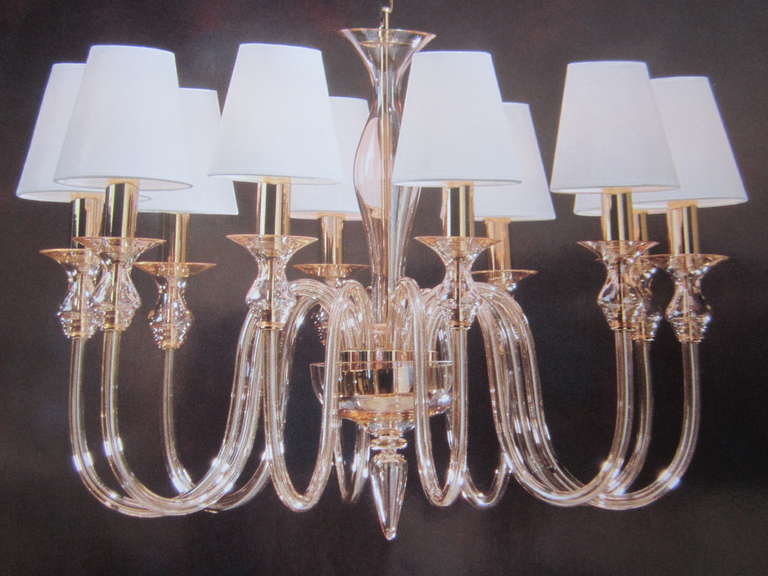Two elegant, dignified handblown mid-century style Venetian glass chandeliers or pendants composed of ten arms in clear glass with brass and gold internal details and ten hardback cloth shades. Clear glass with brass internal details give this