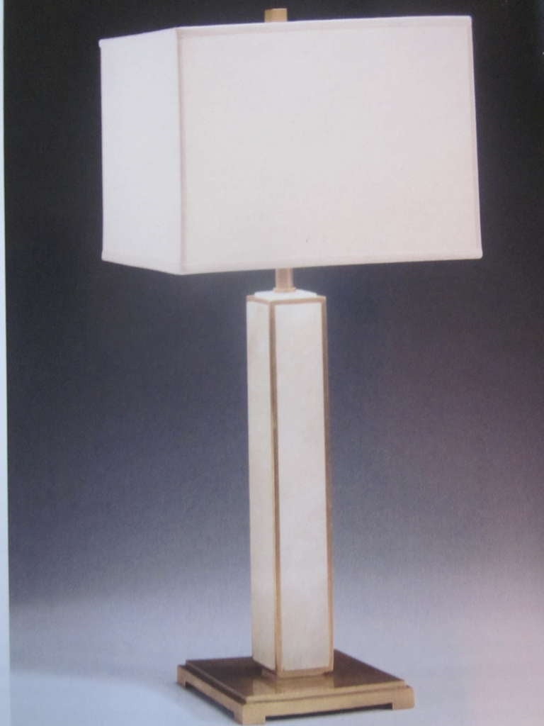 Two elegant pairs of table lamps in the modern neoclassical spirit. The pieces are in the form of columns with solid brass bases and frames and natural alabaster columns. 

Priced and sold as individual pieces.