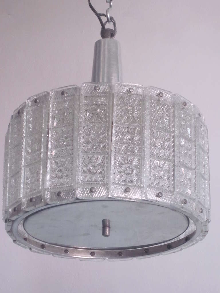 An Austrian Mid-Century Modern flush mount fixture, pendant or chandelier, attributed to J.T. Kalmar, in stainless steel and aluminum with mold blown glass panels surrounding the frame and providing illumination.

Additional References: Max Ingrand,