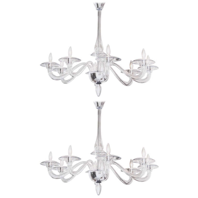 Pair of contemporary Italian midcentury style, clear hand blown Venetian glass chandeliers or pendants in the modern neoclassical style with eight arms attributed to Barovier with blue accents and chrome trim.

Height is 31