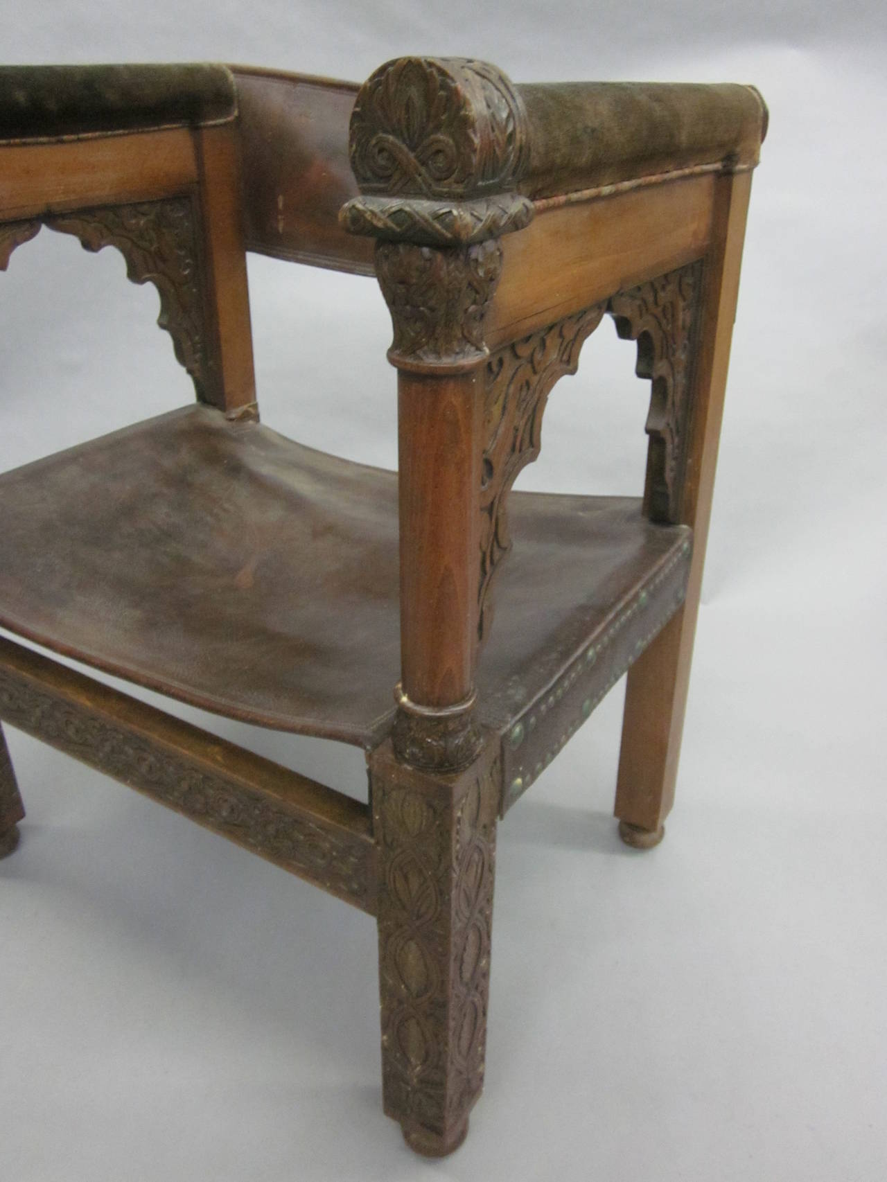 Four Franco-Islamic Carved Wood and Leather Lounge Chairs In Fair Condition For Sale In New York, NY