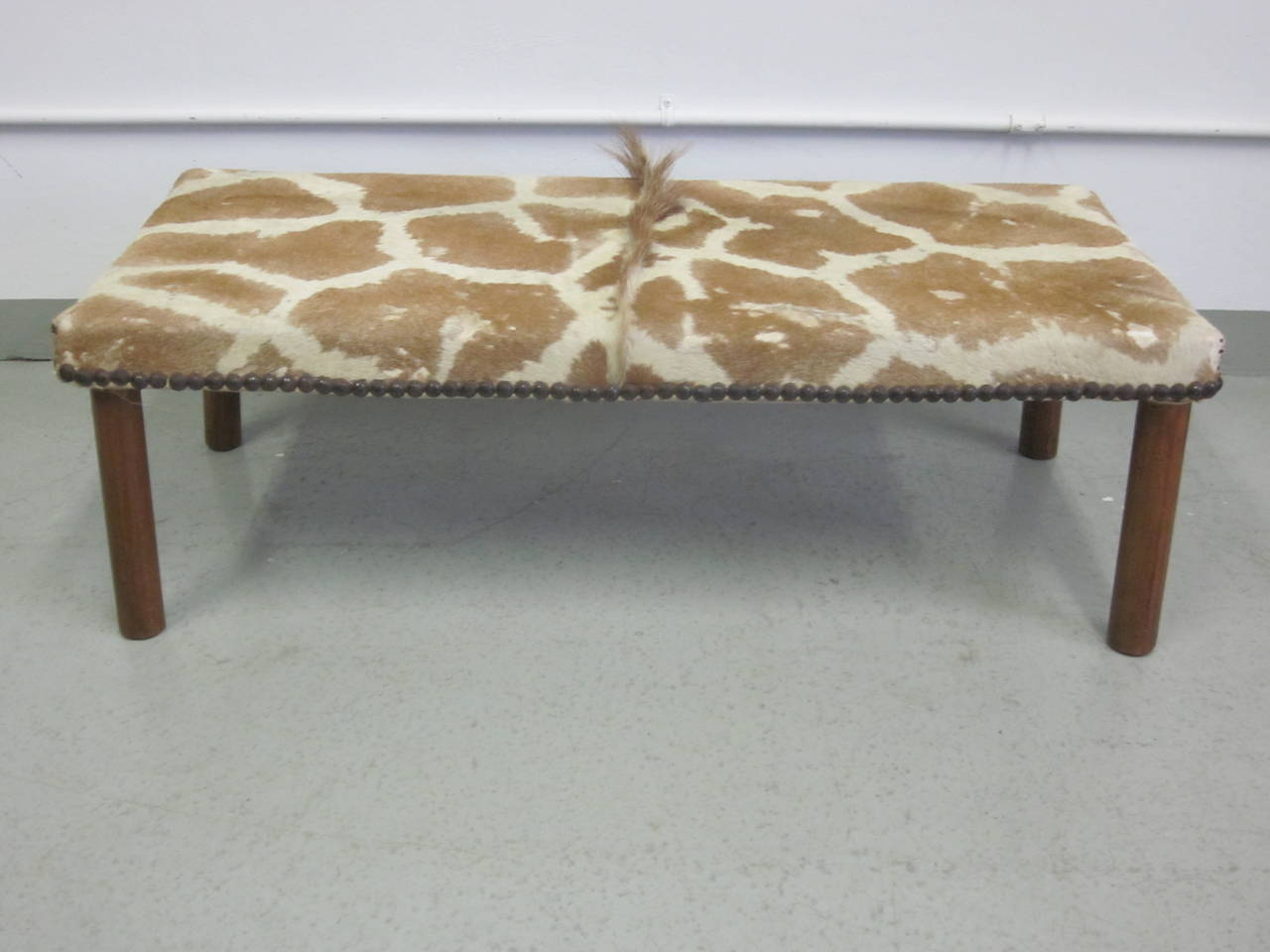 A rare French Modernist bench covered in Giraffe Skin, circa 1930. A sober and exotic piece.