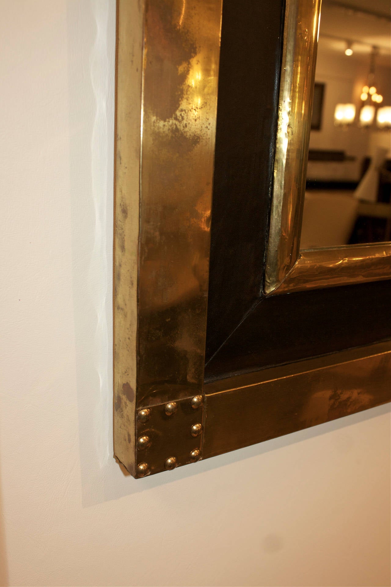 Studded brass and leather frame mirror.