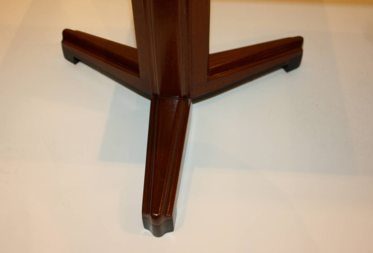 Walnut side tables of the Janus series by Edward Wormley for Dunbar with laminated frame top and dark rosewood accents. 
The shaft and legs are beautifully carved and detailed.