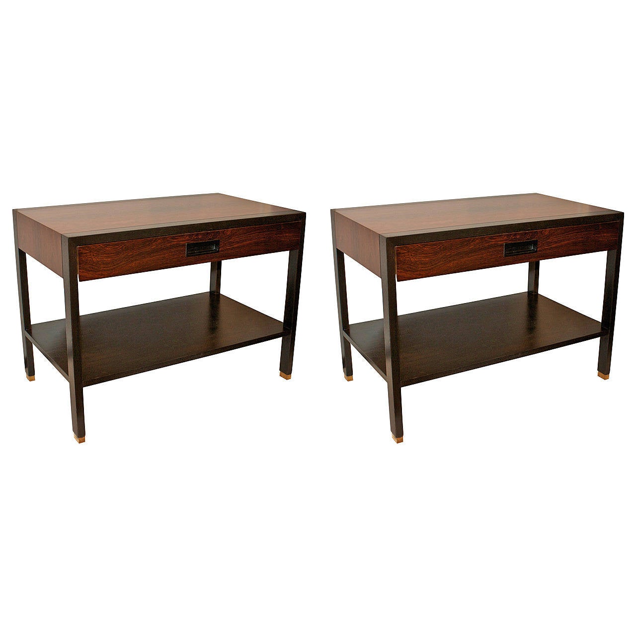 Two-tone side tables by Harvey Probber. The top is walnut with a rosewood bottom tier, frame and handle; the legs have brass accents. Signed.