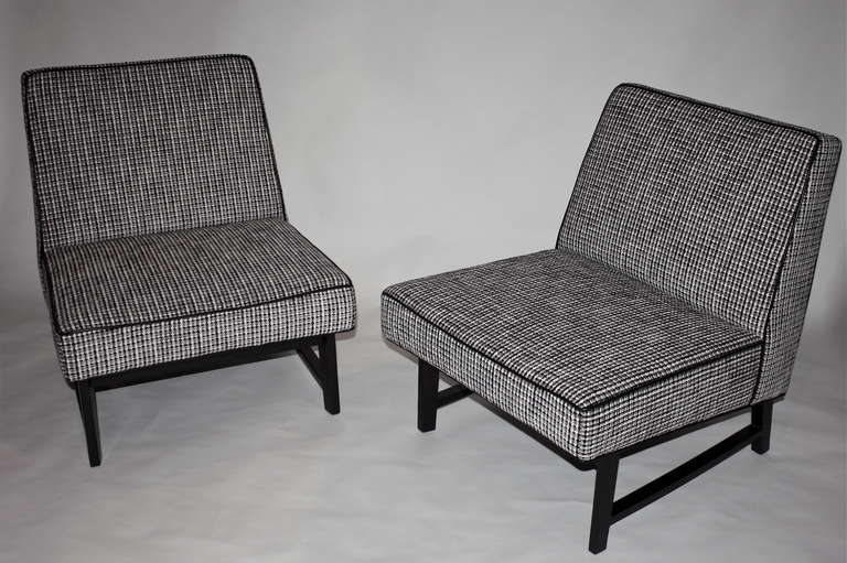Pair of 1950's Edward Wormley for Dunbar slipper chairs upholstered in black and white leather tweed, dark mahogany legs.