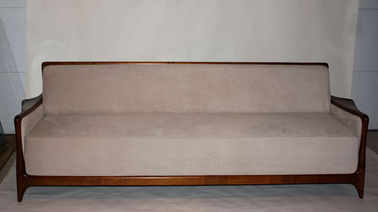 Rare sofa by Vladimir Kagan, made of carved walnut and caning. According to V Kagan, less than 12 were made and he still has two in his own home.

It's worth noting that this example does not convert to a bed and has a few difference with the