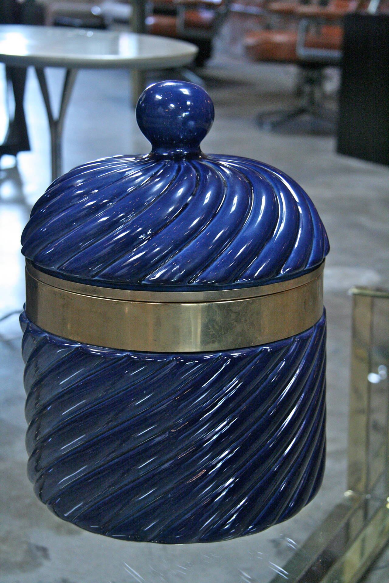 How chic... an ice bucket in blue ceramic and brass by Tommaso Barbi.