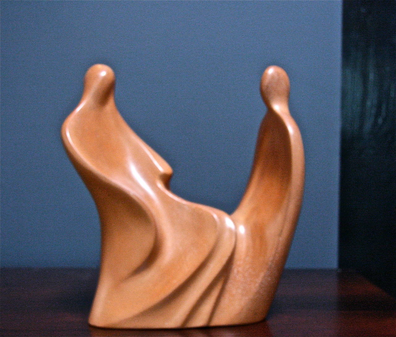 Shiny terra cotta statue entitled "Conversations." What do you think they are talking about? Buy them and find out.